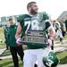 Eastern senior 	Bridger Buche smiles as he carries the Michigan MAC Football Championship trophy off the field after being Western 14-10 at Rynearson Stadium on Saturday afternoon. Melanie Maxwell I AnnArbor.com